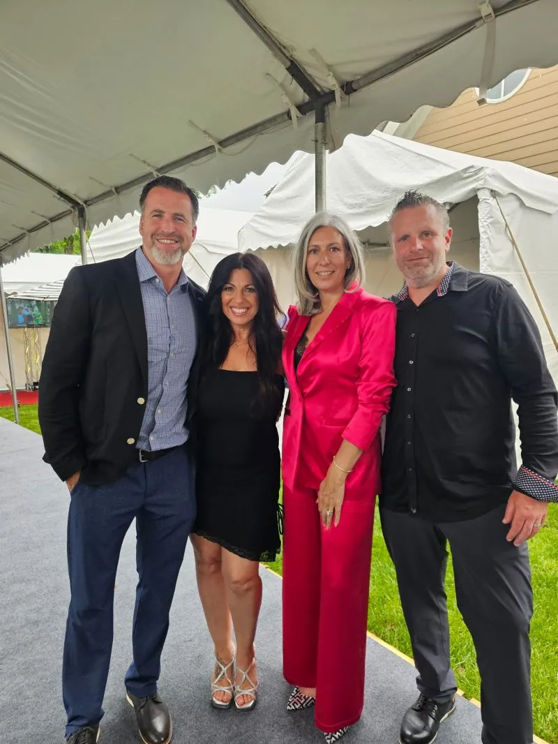 Jamie with three colleagues at an outdoor event